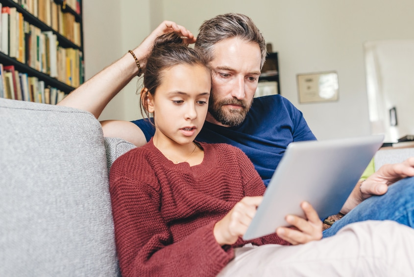 loving father with daughter using digital tablet