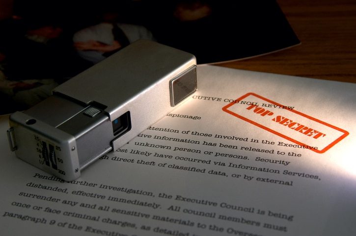 Mini camera and secret documents (photo in upper left is one of my own and contains no recognizable images)